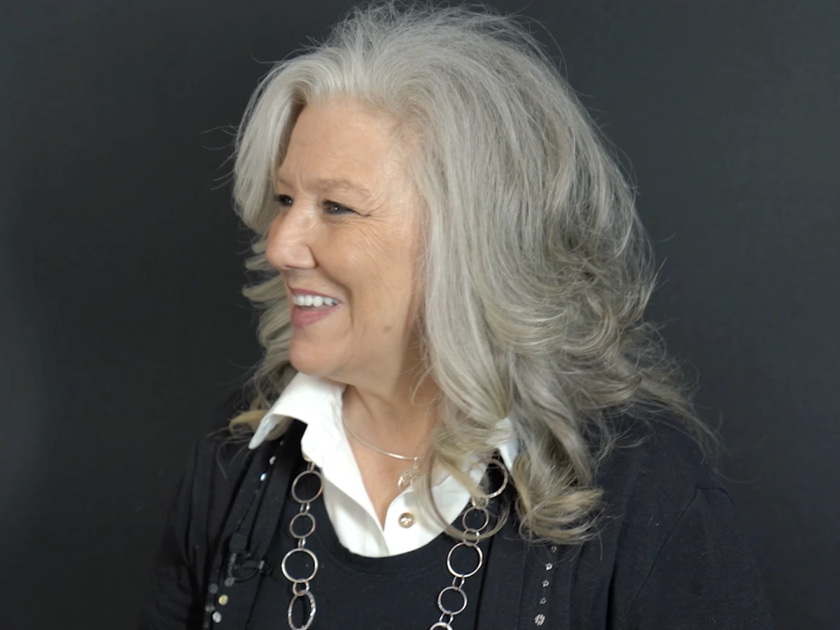 SPG patient smiling after full mouth dental implants